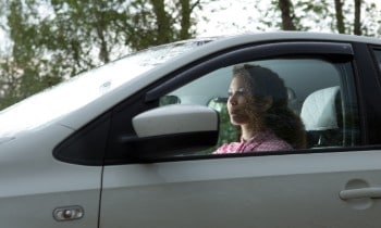 Woman driving, looking through windshield