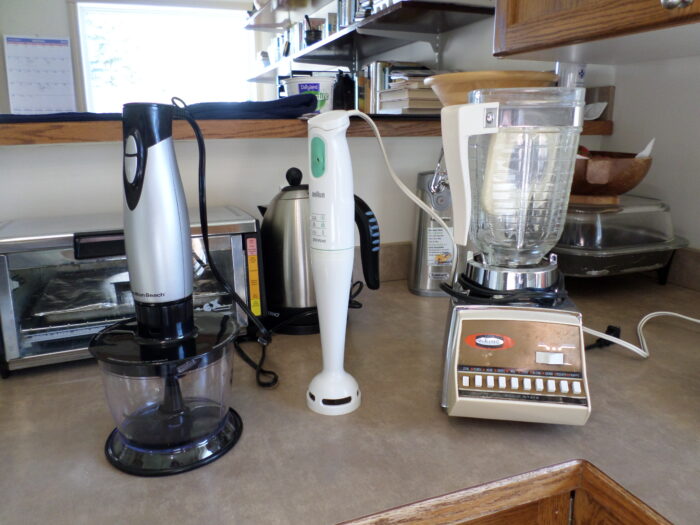 three blenders side by side on a kitchen cabinet