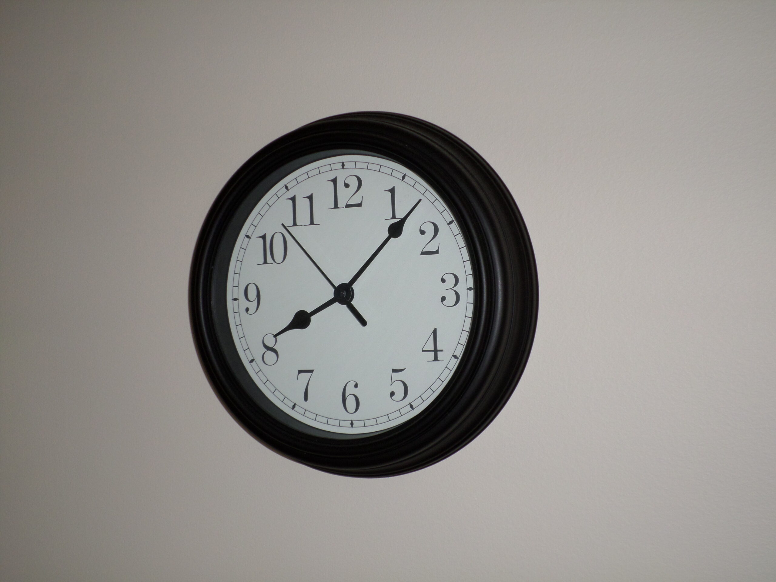 Wall clock, white face, black hands