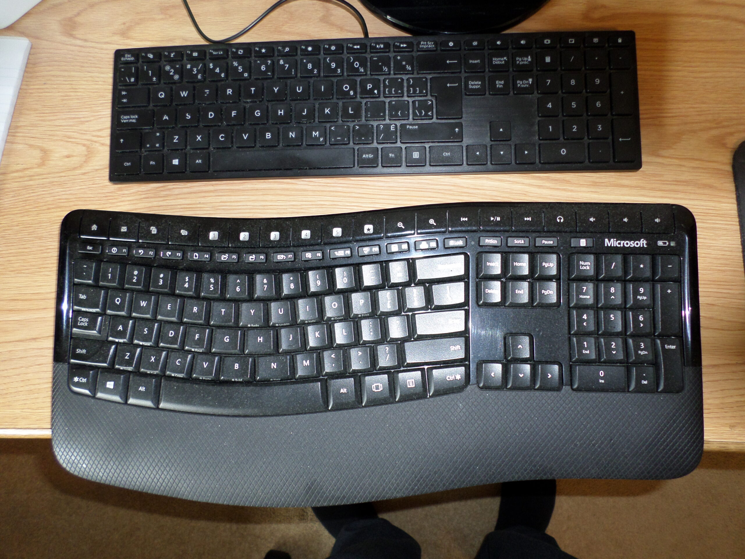 two computer keyboards on desk